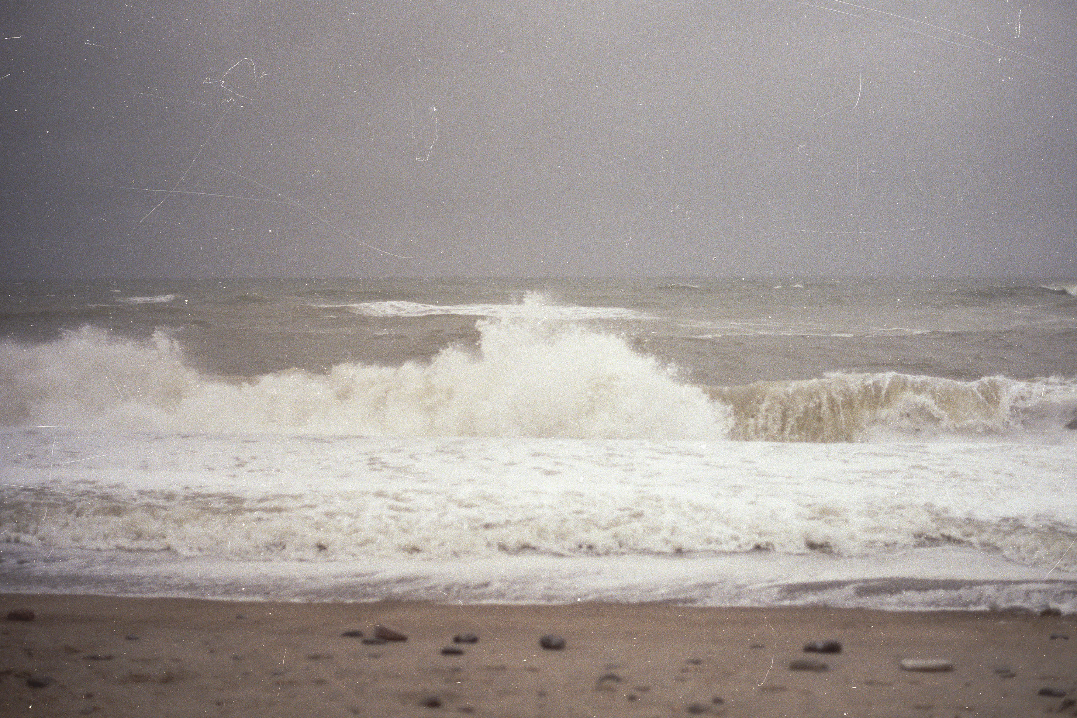 Exhibition promotional photo of a beach featuring the Danish flag.
